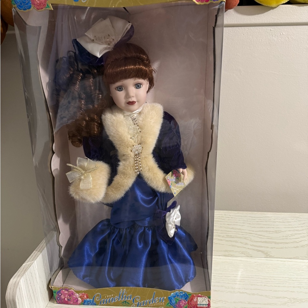 Elegant Blue and White Doll with Floral Accents